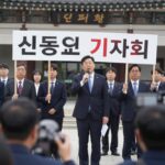 신종오 판사 기자회견 모습, 법원 앞에서 항의 피켓을 들고 있는 장면