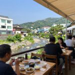 Donghaksa valley restaurant terrace with view of stream and tables
